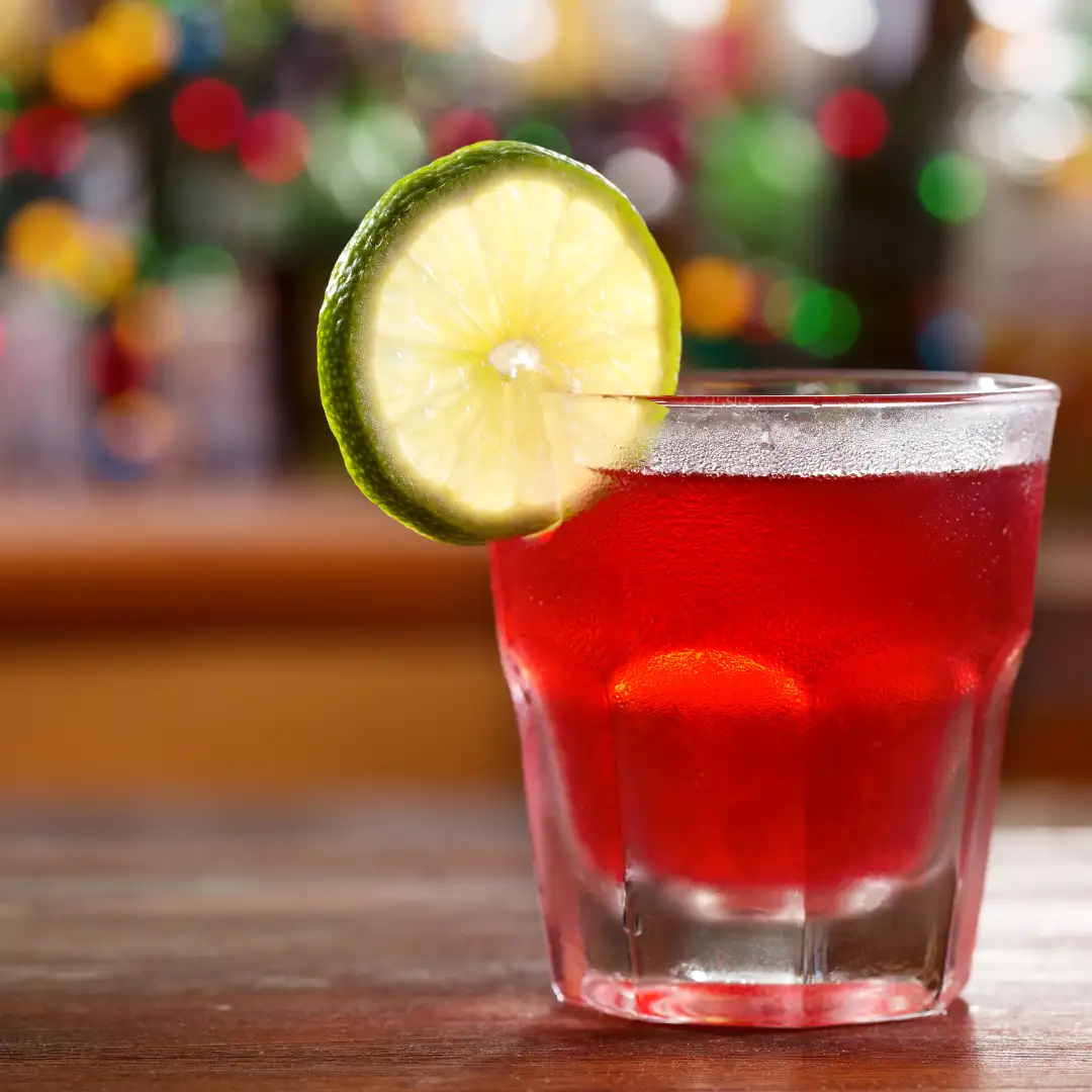 Cosmopolitan Cocktail Recipe with a Lime slice on the rim of the glass