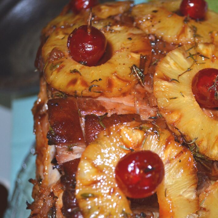 Ham With A Passion Fruit Glaze Recipe with Cherries and Pineapple rings on the outside of the ham