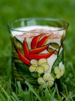 Tropical Eggnog Recipe in a painted glass with tropical flowers