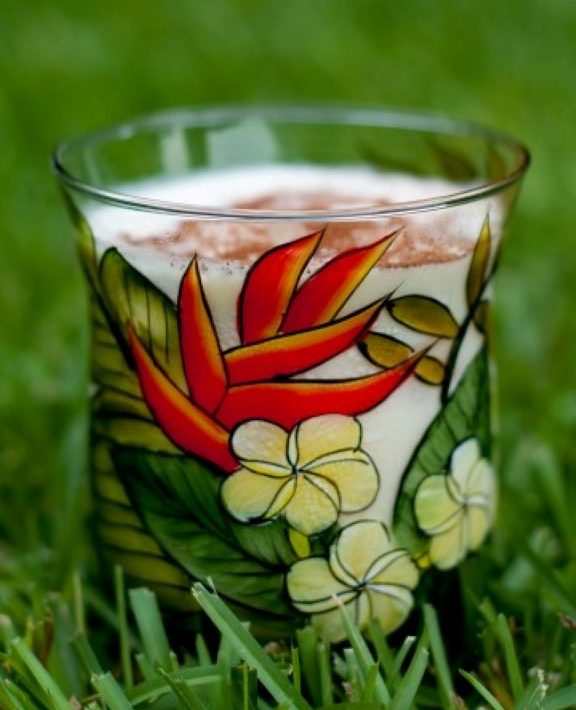 Tropical Eggnog Recipe in a painted glass with tropical flowers
