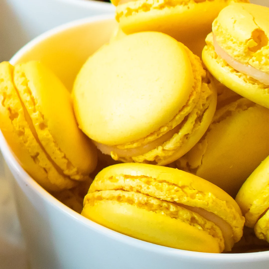 Yellow Passion Fruit Macarons in a white bowl