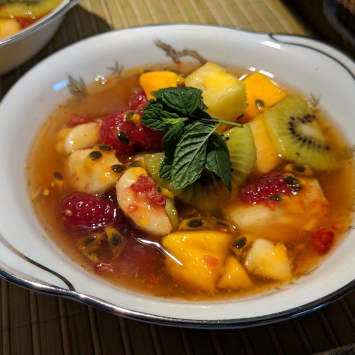 Cold Passion Fruit Soup in a bowl with mint leaves
