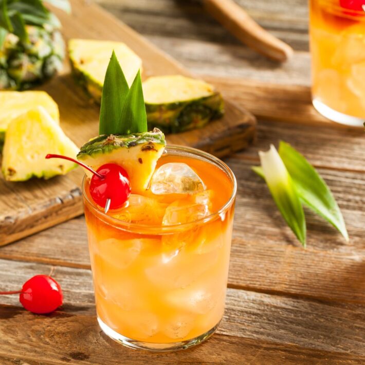 Passion Fruit Mai Tai Recipe with a cherry and pineapple sprigs to garnish