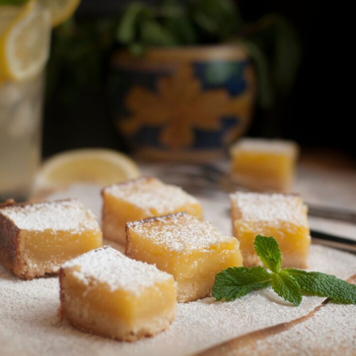 Lilikoi Coconut Bars Recipe Sprinkled with powdered sugar and garnished with mint