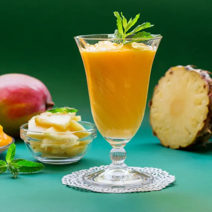 Hawaiian Passion Smoothie With Pineapple and mango on a green tablecloth